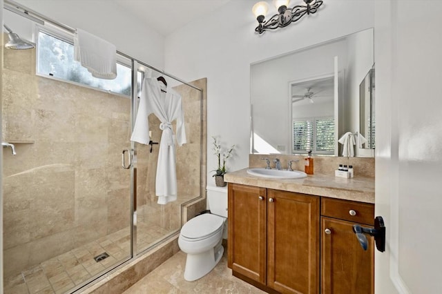 bathroom featuring ceiling fan, tile patterned floors, an enclosed shower, toilet, and vanity