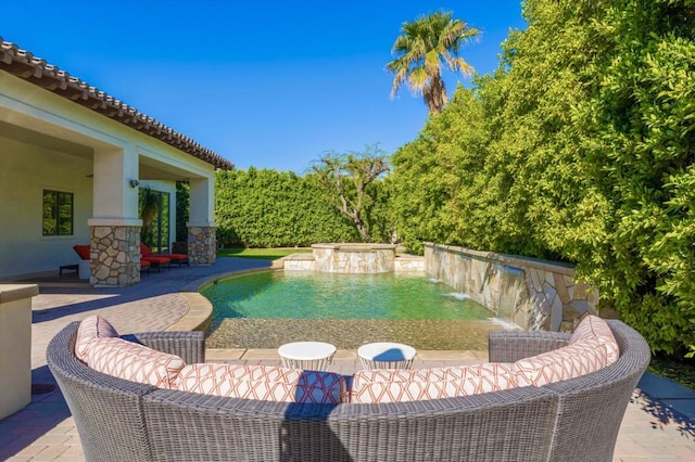 view of swimming pool with an outdoor living space, a patio area, and a hot tub