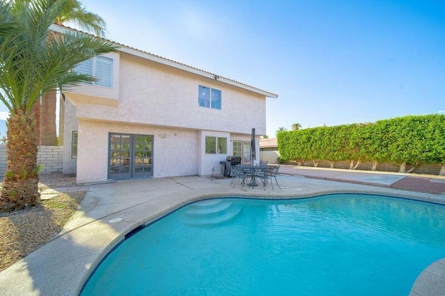 view of swimming pool with a patio and area for grilling