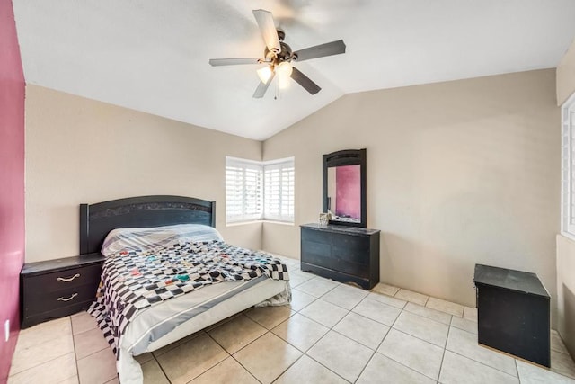 bedroom with lofted ceiling, light tile patterned floors, and ceiling fan