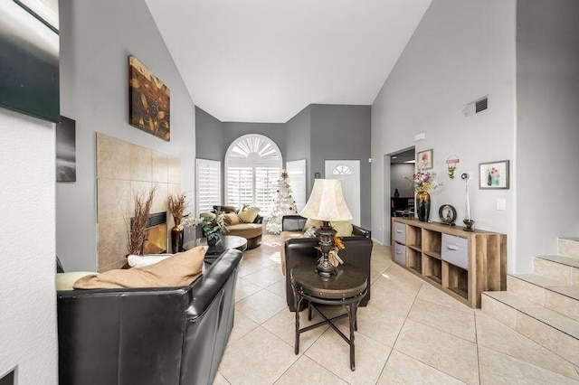 living room featuring high vaulted ceiling and light tile patterned floors