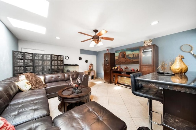 living room featuring ceiling fan and light tile patterned floors