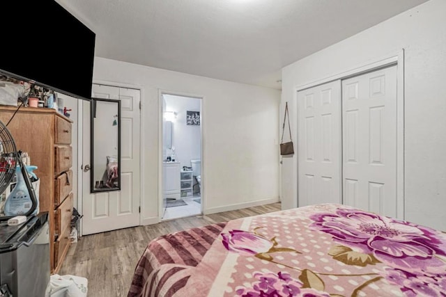 bedroom featuring ensuite bath and light wood-type flooring