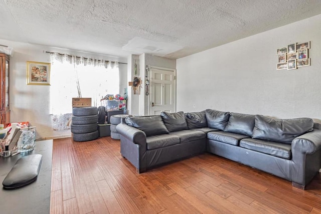 living room featuring hardwood / wood-style floors and a textured ceiling