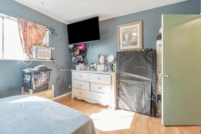 bedroom with light wood-type flooring and cooling unit