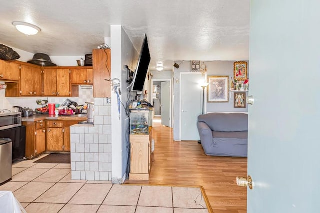 kitchen featuring decorative backsplash and light wood-type flooring