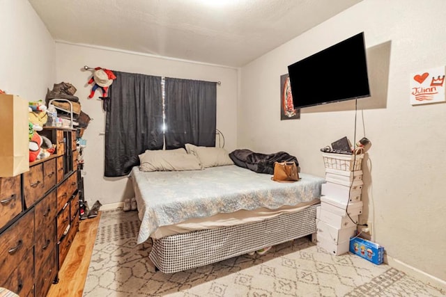 bedroom with wood-type flooring