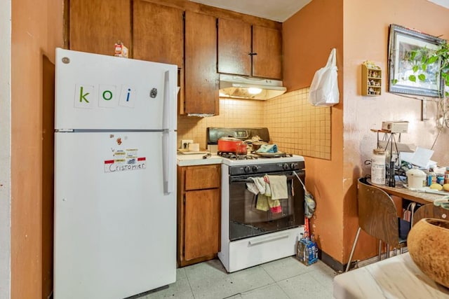 kitchen with decorative backsplash and white appliances