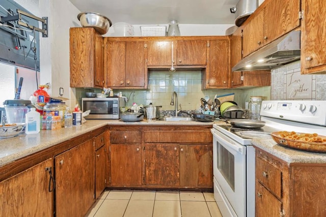 kitchen with white range with electric stovetop, light tile patterned flooring, decorative backsplash, and sink