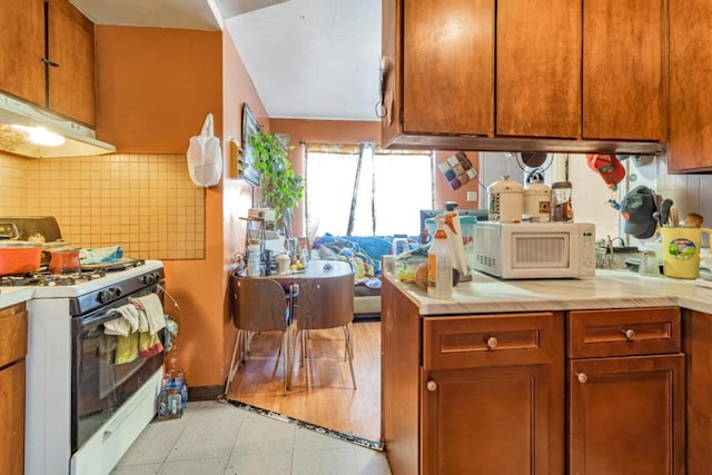 kitchen with tasteful backsplash and white appliances