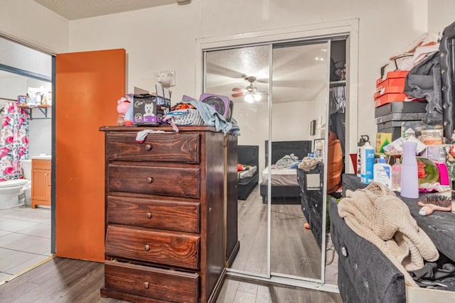 bedroom with a closet, a textured ceiling, and hardwood / wood-style flooring