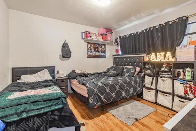 bedroom with hardwood / wood-style flooring