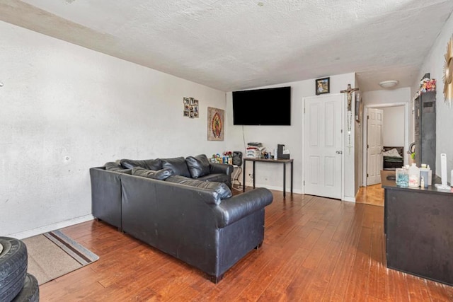 living room with hardwood / wood-style floors and a textured ceiling