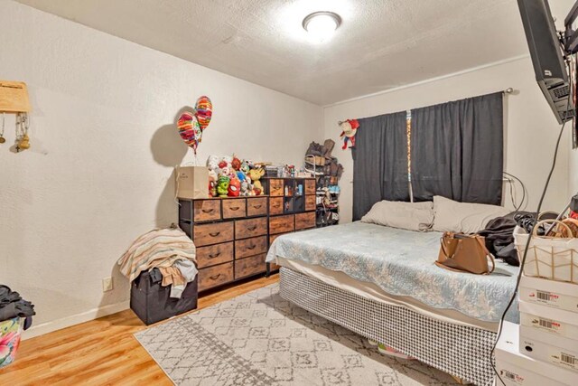 bedroom with hardwood / wood-style floors