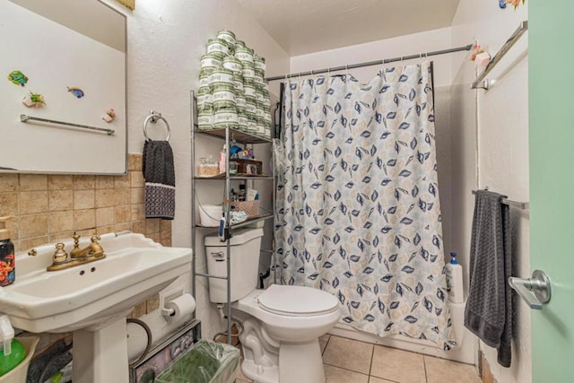 bathroom with tile patterned flooring, curtained shower, toilet, and tasteful backsplash