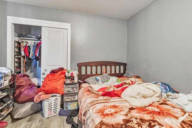 bedroom featuring hardwood / wood-style floors and a closet