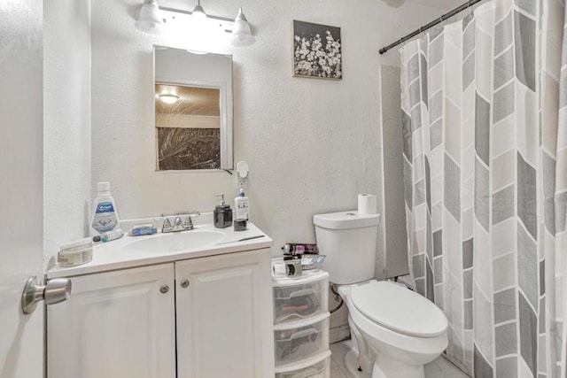 bathroom featuring vanity, a shower with shower curtain, and toilet