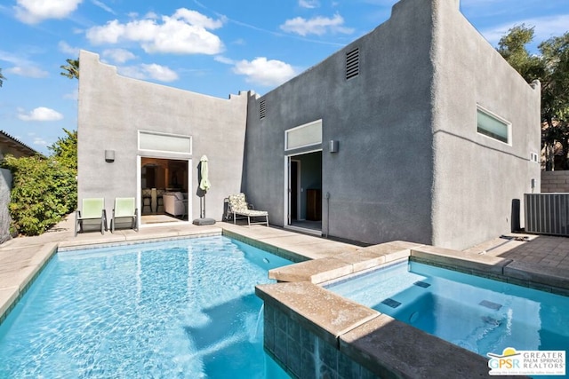 view of pool with an in ground hot tub, a patio, and central AC