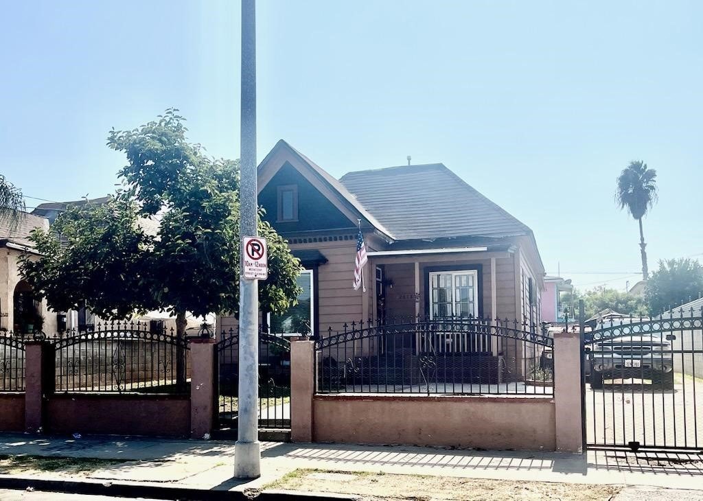 bungalow-style house featuring a gate and a fenced front yard