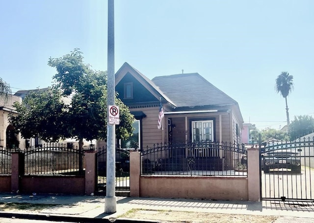 bungalow-style house featuring a gate and a fenced front yard