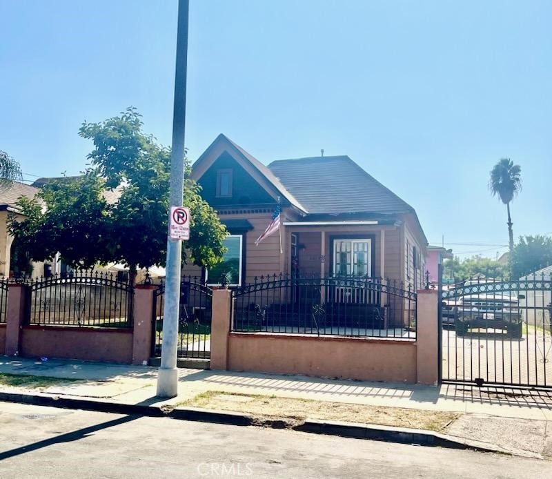 bungalow-style home featuring a gate and a fenced front yard