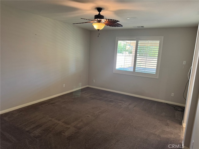 carpeted spare room with ceiling fan