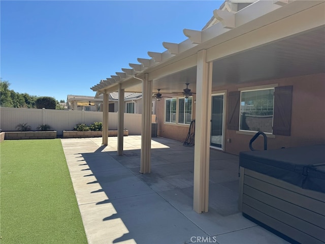 view of patio featuring ceiling fan, a pergola, and a hot tub