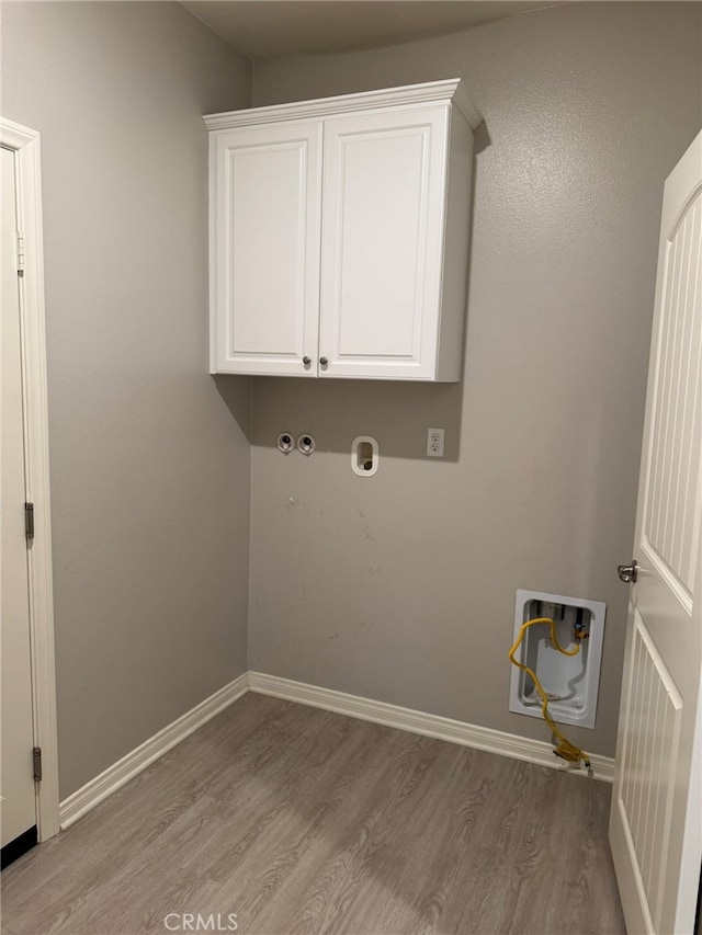 washroom featuring washer hookup and light hardwood / wood-style floors