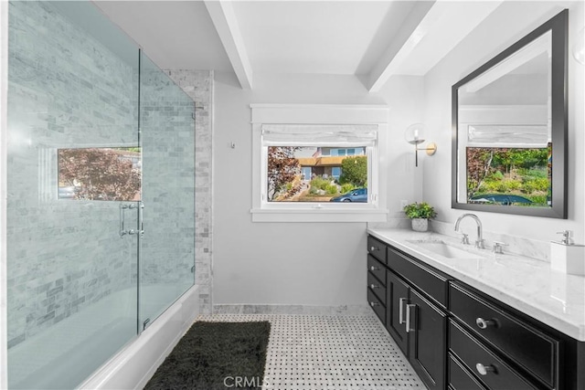 bathroom with combined bath / shower with glass door, vanity, and a wealth of natural light