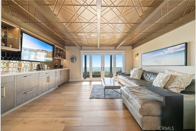 living room with french doors and light wood-type flooring