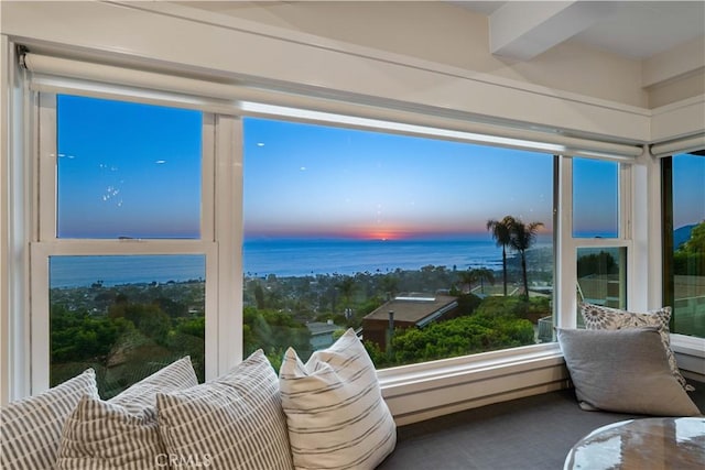 sunroom / solarium featuring a water view