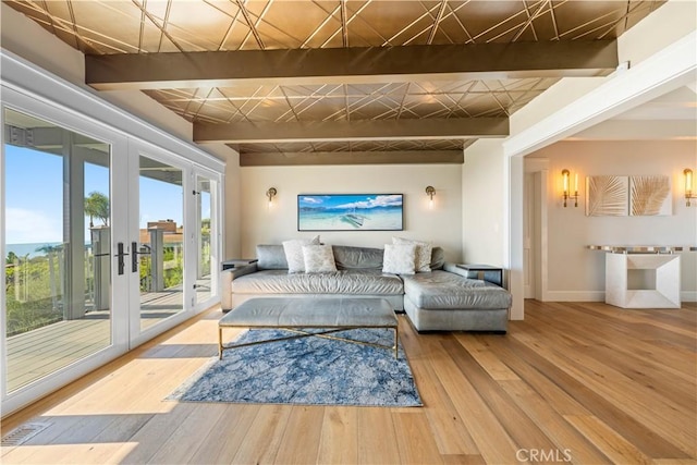 interior space with beamed ceiling, french doors, and wood-type flooring