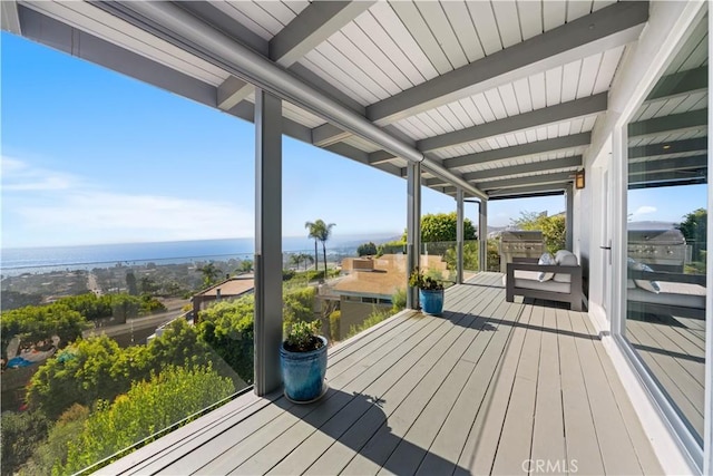 wooden terrace featuring a water view