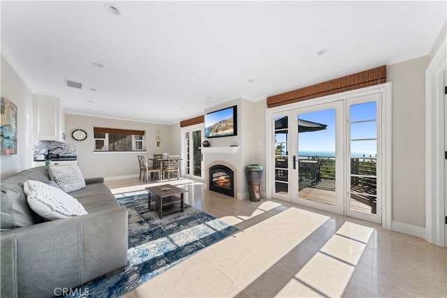 living room with crown molding and light tile patterned floors