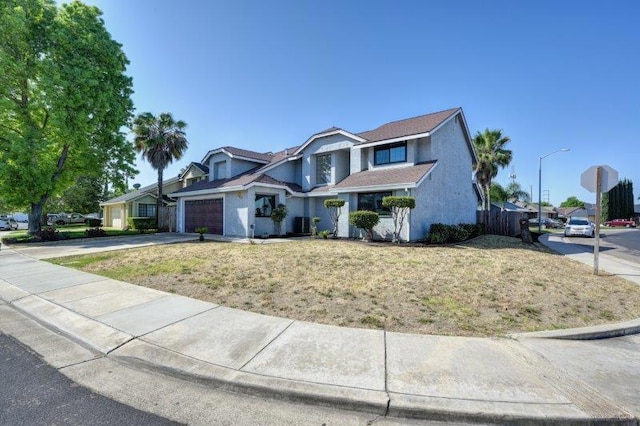 front facade featuring a front lawn and a garage