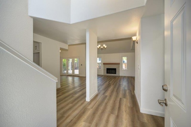 entryway with wood-type flooring and a chandelier