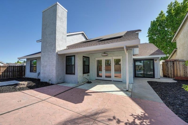 rear view of property featuring a patio area and ceiling fan