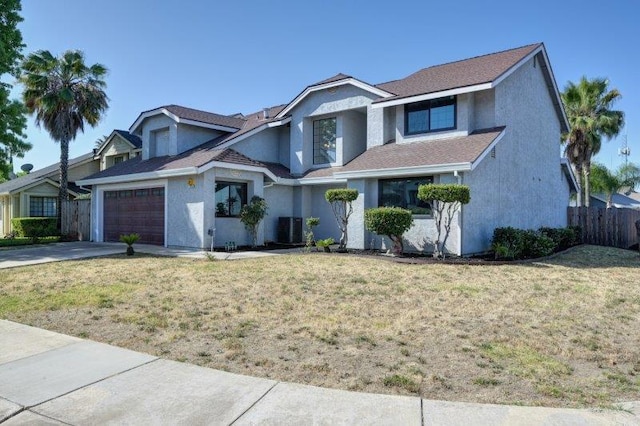 view of front facade featuring a front yard and central AC unit