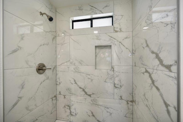 bathroom with tiled shower