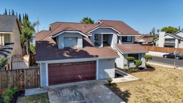 view of front property featuring a front lawn and a garage