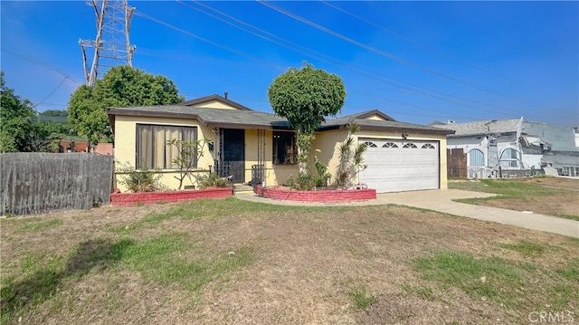 view of front of property with a front lawn and a garage