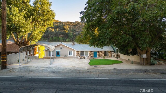 view of front facade with a mountain view and a carport