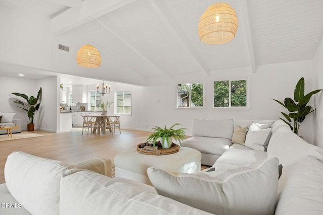 living room with beamed ceiling, high vaulted ceiling, light hardwood / wood-style flooring, and a notable chandelier