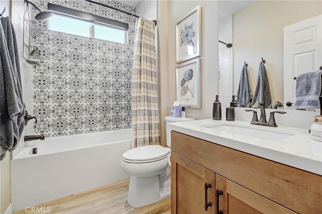 full bathroom featuring wood-type flooring, toilet, vanity, and shower / bath combo