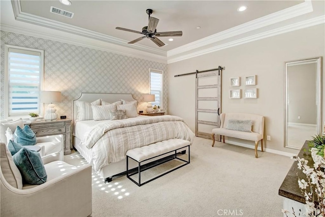 bedroom with ceiling fan, ornamental molding, light carpet, and a barn door