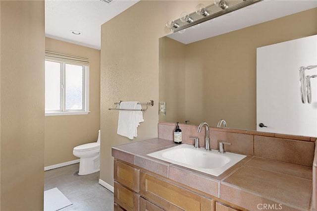 bathroom featuring toilet and vanity