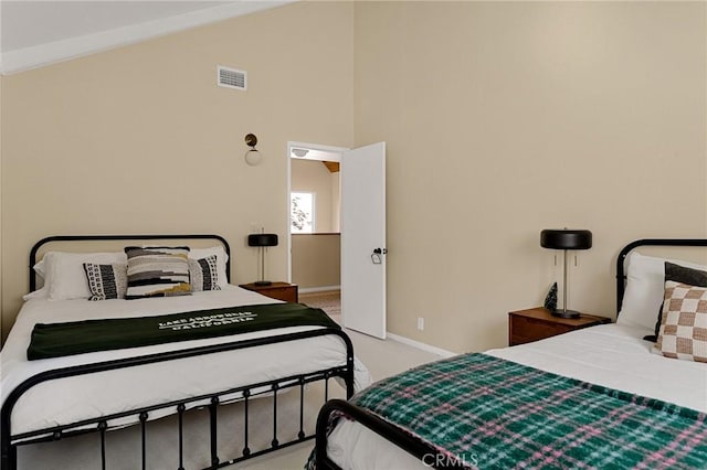 carpeted bedroom with lofted ceiling