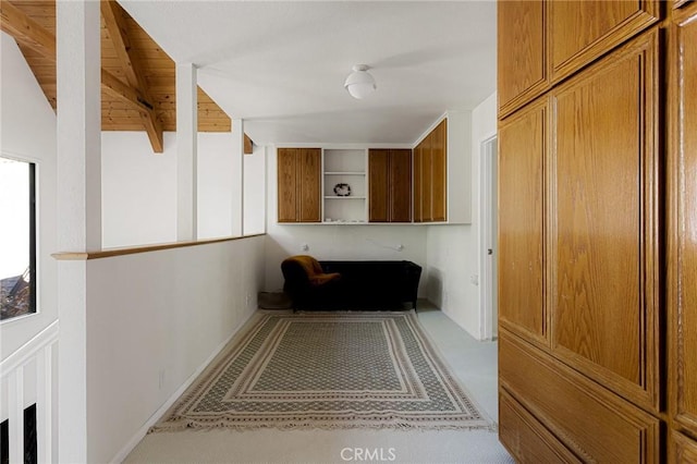 hallway featuring wooden ceiling and vaulted ceiling with beams