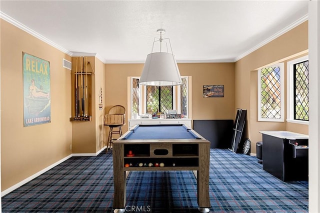 rec room featuring plenty of natural light, ornamental molding, and dark colored carpet