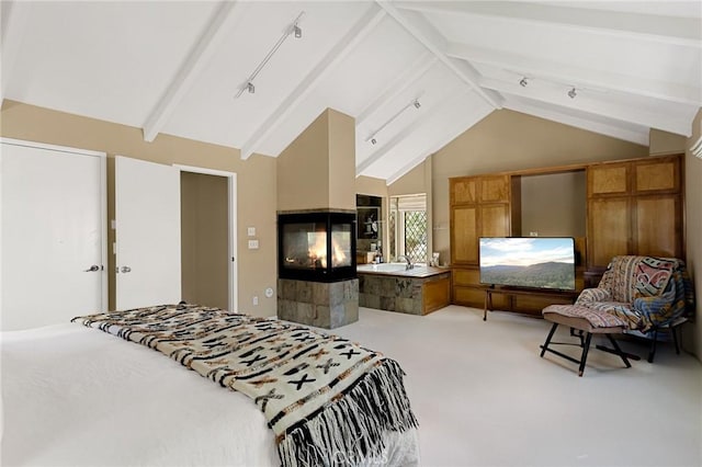 bedroom featuring carpet floors, high vaulted ceiling, beam ceiling, and a tiled fireplace